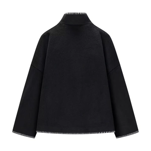Back view of black wool jacket featuring white whipstitch trim on high collar and hem