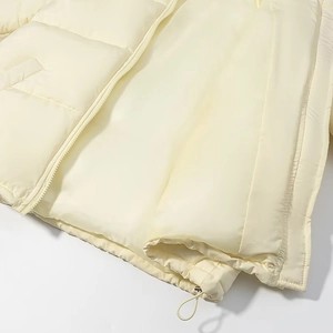 Detailed macro view of the horizontal quilting, zipper closure, and adjustable drawstring hem