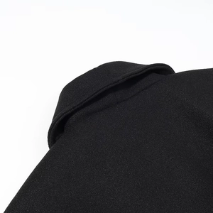 Gros plan détaillé sur la texture en laine noire du revers et de l'épaule