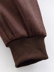 Detail view of dark brown faux suede sleeve with matching elastic ribbed knit cuffs