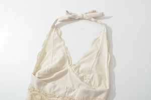 Detail of lace hollow-out embroidery and back bowknot on beige halter neck dress