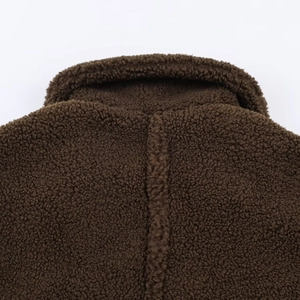 Close-up of deep brown sherpa fleece texture on a warm lapel winter coat for women