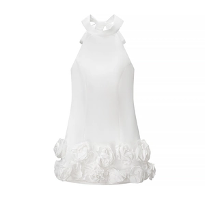 Detail view of white halter neck mini dress with 3D rose floral ruffles on the hemline