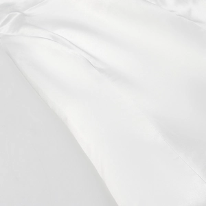Close-up of premium white satin fabric with elegant drape and smooth glossy finish
