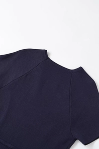 Detail of navy blue knit top featuring a round neckline and raglan sleeve stitching