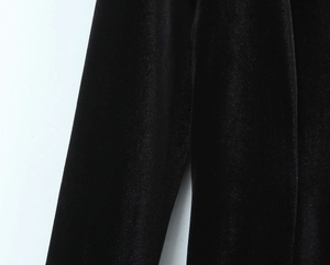 Detail of premium black velvet fabric texture with soft sheen on short dress sleeve