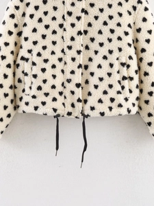 Detail of soft heart print fleece jacket showing adjustable drawstring hem and plush texture