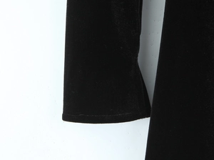 Close-up of velvet fabric texture and sleeve stitching on black slim A-line dress