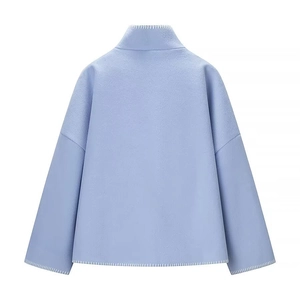 Back view of light blue wool coat featuring decorative white hand-stitched detailing