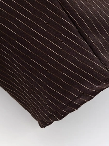 Macro view of dark brown striped fabric with a detailed twill weave structure