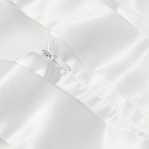 Detailed macro shot of high-quality invisible zipper on a white satin dress