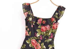 Detail of vintage floral dress with red roses, frilled square neckline and shoulder straps
