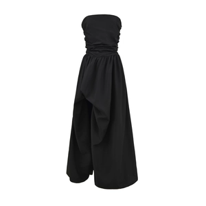 Detail of elegant black strapless dress featuring layered pleats and slit hem