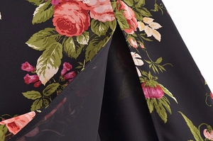 Detailed close-up of French vintage rose floral print and dress hem slit craftsmanship