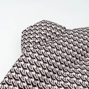Close-up of modern geometric black and white patterned fabric with thick woven texture