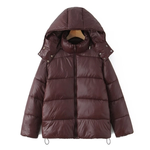 Close-up of shiny burgundy winter puffer jacket with hood and metal button details