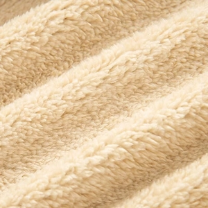 Close-up of soft cream faux fur lining texture on a winter short puffer jacket