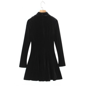 Detailed view of black velvet dress with high collar and slim-fit A-line silhouette