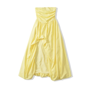 Close-up of the pleated bodice and layered high-low hem on light yellow tube dress