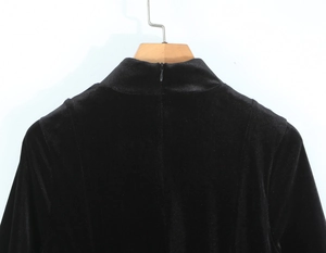 Detailed view of black velvet high-neck collar with invisible back zipper for dresses