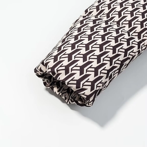 Close-up of puffy elastic cuffs on winter padded jacket with geometric Y-pattern print