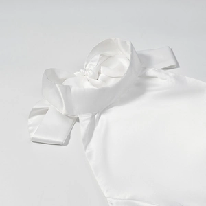 Elegant white satin halter dress with a large decorative bow on the neckline