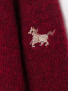 Detailed view of luxury wine red knit cardigan featuring white beaded animal embroidery