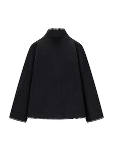 Minimalist black wool coat with white contrast stitching and high collar back view