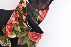 Macro detail of French vintage floral dress with red roses and ruffled elastic smocking