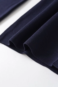 Close-up of the premium dark blue knitted fabric with a smooth finish and fine texture