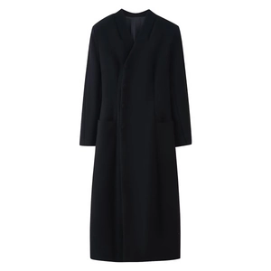 Macro detail of high-quality black wool coat showing button closure and fabric texture