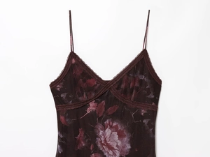 Close-up of floral print dress featuring delicate lace trim on V-neckline and dual straps