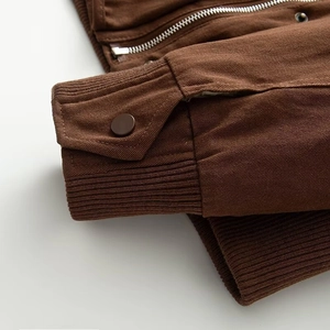Close-up of heavy cotton jacket with metal snap button cuffs and ribbed knit details