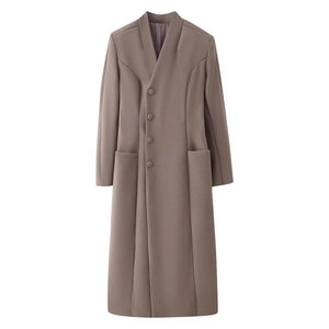 Close-up of mocha brown wool coat showing stand collar detail and premium fabric texture
