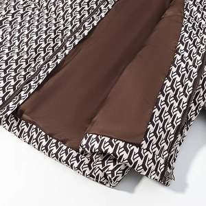 Detailed close-up of winter jacket with Y-pattern print and smooth brown lining