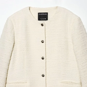 Classic cream tweed jacket with round neck and metallic buttons for elegant street fashion