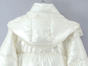 Detail of white glossy puffer jacket showing hood and horizontal quilted back stitching
