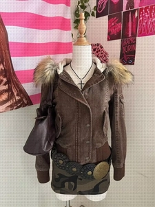 Detailed close-up of brown utility jacket with detachable faux fur collar and ribbed cuffs