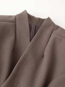 Detail shot of the stand collar and smooth brown lining of this wool coat