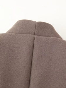 Macro shot of back collar seam on taupe wool blend coat with detailed cross stitching