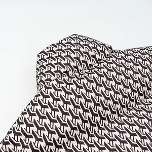 Winter street style padded coat with black and white geometric pattern in segmented padding