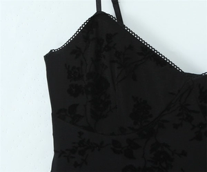 Detail of floral flocked fabric with lace trim on a black camisole mini dress