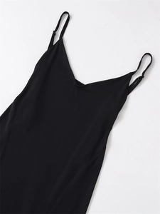 Detail of black V-neck slip dress showing adjustable thin shoulder straps and slim fit