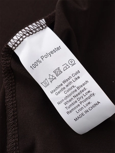 Detailed view of the garment label showing 100% Polyester composition and care instructions