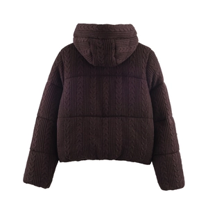 Detail view of winter brown hooded jacket with unique cable knit texture and quilting