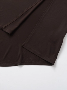 Detail of double-needle stitching on the hem of a slim-fit dark brown dress fabric