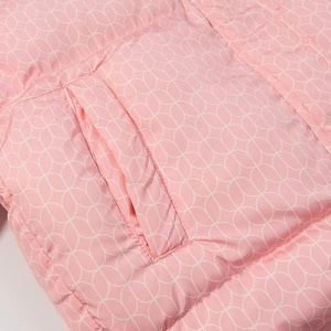 Detail of pink quilted jacket featuring white floral print and diagonal side pocket seam
