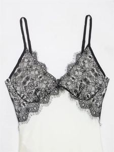 Close-up of black floral lace camisole featuring delicate eyelash trim and adjustable straps