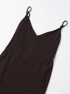 Detail of V-neckline and adjustable metal buckles on dark brown slim fit dress