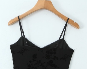 Detail of black camisole with jacquard floral texture and adjustable straps